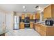 Kitchen with stainless steel appliances and wood cabinets at 910 Nancy Ct, Kissimmee, FL 34759