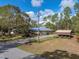 Single-story home with attached garage and large backyard on a tree-lined street at 9365 Lemon Dr, Lake Wales, FL 33898