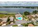 Aerial view of community pool, lake, and homes at 3909 Cypress E Lndg, Winter Haven, FL 33884