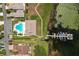 Aerial view showing community pool and lake access at 3909 Cypress E Lndg, Winter Haven, FL 33884