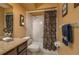 Bathroom features a shower/tub combo, granite countertop and dark wood vanity at 3909 Cypress E Lndg, Winter Haven, FL 33884