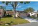Front view of a tan house with a large tree and holiday decorations at 3909 Cypress E Lndg, Winter Haven, FL 33884