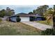 Blue house with white garage door and landscaping at 1001 Mockingbird Cir, Winter Haven, FL 33884