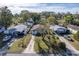 Three houses with driveways, green lawns, and tree cover at 1244 W 9Th St, Lakeland, FL 33805
