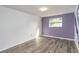 Empty bedroom with hardwood floors and purple accent wall at 1244 W 9Th St, Lakeland, FL 33805