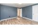 Blue-walled bedroom with hardwood floors and access to bathroom at 1244 W 9Th St, Lakeland, FL 33805
