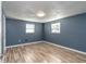 Simple bedroom with hardwood floors and blue walls at 1244 W 9Th St, Lakeland, FL 33805