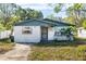 Cute one-story house with a landscaped yard and a driveway at 1244 W 9Th St, Lakeland, FL 33805