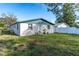 Back of house, light colored with blue trim, and a grassy yard at 1244 W 9Th St, Lakeland, FL 33805