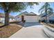 House exterior featuring a two-car garage and well-maintained landscaping at 130 Sonja Cir, Davenport, FL 33897