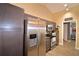 Kitchen with stainless steel refrigerator and dark cabinets at 1490 Meadows Pond Dr, Bartow, FL 33830