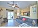 Open living area with gray couch and view of kitchen at 1490 Meadows Pond Dr, Bartow, FL 33830