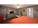 Main bedroom with a large bed, dresser and adjacent bathroom at 1490 Meadows Pond Dr, Bartow, FL 33830
