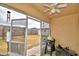 Relaxing screened porch with ceiling fan, backyard view, and room for grilling at 1490 Meadows Pond Dr, Bartow, FL 33830