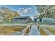 Wooden walkway leads to a waterfront home with a screened-in porch at 1769 S Lake Reedy Blvd, Frostproof, FL 33843