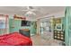 Cozy bedroom with a red bedspread and sliding glass door at 1769 S Lake Reedy Blvd, Frostproof, FL 33843