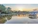 Private waterfront dock with covered boat slip at sunset at 1769 S Lake Reedy Blvd, Frostproof, FL 33843