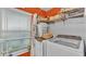 Bright laundry room with washer, dryer, and storage shelves at 1769 S Lake Reedy Blvd, Frostproof, FL 33843