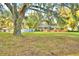 House with a large backyard and mature oak trees at 2036 Lake Ariana Blvd, Auburndale, FL 33823