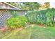 Charming backyard with lush greenery and a lattice fence at 2036 Lake Ariana Blvd, Auburndale, FL 33823