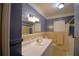 Updated bathroom with a tub and separate vanity at 2036 Lake Ariana Blvd, Auburndale, FL 33823