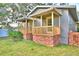 Gray house with a brick-accented porch and large yard at 2036 Lake Ariana Blvd, Auburndale, FL 33823