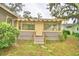 House with a yellow door, steps, and a sunroom at 2036 Lake Ariana Blvd, Auburndale, FL 33823