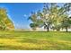 Open lawn with a scenic view of a calm lake at 2036 Lake Ariana Blvd, Auburndale, FL 33823