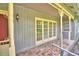 Brick porch with French doors and columns at 2036 Lake Ariana Blvd, Auburndale, FL 33823