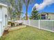 Landscaped backyard with raised garden beds and seating at 235 Lake Suzanne Dr, Lake Wales, FL 33859