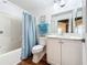 Bathroom with a white vanity, toilet and a tub shower combo at 235 Lake Suzanne Dr, Lake Wales, FL 33859