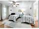 Bedroom with two twin beds, a ceiling fan and a sitting area at 235 Lake Suzanne Dr, Lake Wales, FL 33859