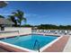 Community pool with lounge chairs and lake view at 235 Lake Suzanne Dr, Lake Wales, FL 33859