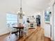 Bright dining area with a wooden table, chandelier, and a view to the kitchen at 235 Lake Suzanne Dr, Lake Wales, FL 33859