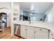 Modern kitchen with white cabinets, stainless steel appliances, and quartz countertops at 235 Lake Suzanne Dr, Lake Wales, FL 33859
