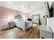 Main bedroom with pink accent wall and en-suite bathroom at 235 Lake Suzanne Dr, Lake Wales, FL 33859