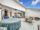 Inviting screened patio with hot tub and comfortable seating at 235 Lake Suzanne Dr, Lake Wales, FL 33859