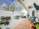 Relaxing screened patio with hot tub, seating area, and dining table at 235 Lake Suzanne Dr, Lake Wales, FL 33859