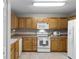 Well-equipped kitchen with light wood cabinets and white appliances at 3421 Grenville Dr, Winter Haven, FL 33884