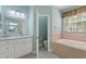 Bathroom with a tub, shower, and updated vanity at 357 Magneta Loop, Auburndale, FL 33823