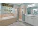 Bathroom boasts a shower, tub, and white cabinets at 357 Magneta Loop, Auburndale, FL 33823