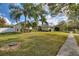 Landscaped yard with a two-story house and palm trees at 357 Magneta Loop, Auburndale, FL 33823