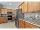 Kitchen boasts granite countertops and wood cabinets at 357 Magneta Loop, Auburndale, FL 33823