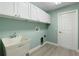 Laundry room with built-in cabinets and utility sink at 357 Magneta Loop, Auburndale, FL 33823