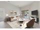 Living room features a comfy sofa and pool access at 357 Magneta Loop, Auburndale, FL 33823