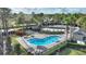 Community pool area with a clubhouse and palm trees at 357 Magneta Loop, Auburndale, FL 33823