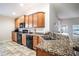 Kitchen with wood cabinets, granite countertops and black appliances at 4023 Island Lakes Dr, Winter Haven, FL 33881