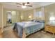 Spacious bedroom with ceiling fan, mirrored closet and comfortable bed at 6308 Bayberry Ne Blvd, Winter Haven, FL 33881