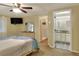 Main bedroom with ensuite bathroom access and a large TV at 6308 Bayberry Ne Blvd, Winter Haven, FL 33881