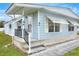 Mobile home with light blue siding and covered porch at 6308 Bayberry Ne Blvd, Winter Haven, FL 33881
